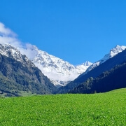 **Alt Text:** "Autumn in Verbier with snow-covered mountain tops, showcasing a beautiful contrast of fall foliage and early winter snow in the Swiss Alps."